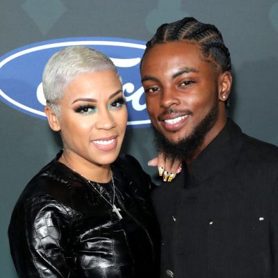 Both of them are dressed in black while Keyshia has short white hair.